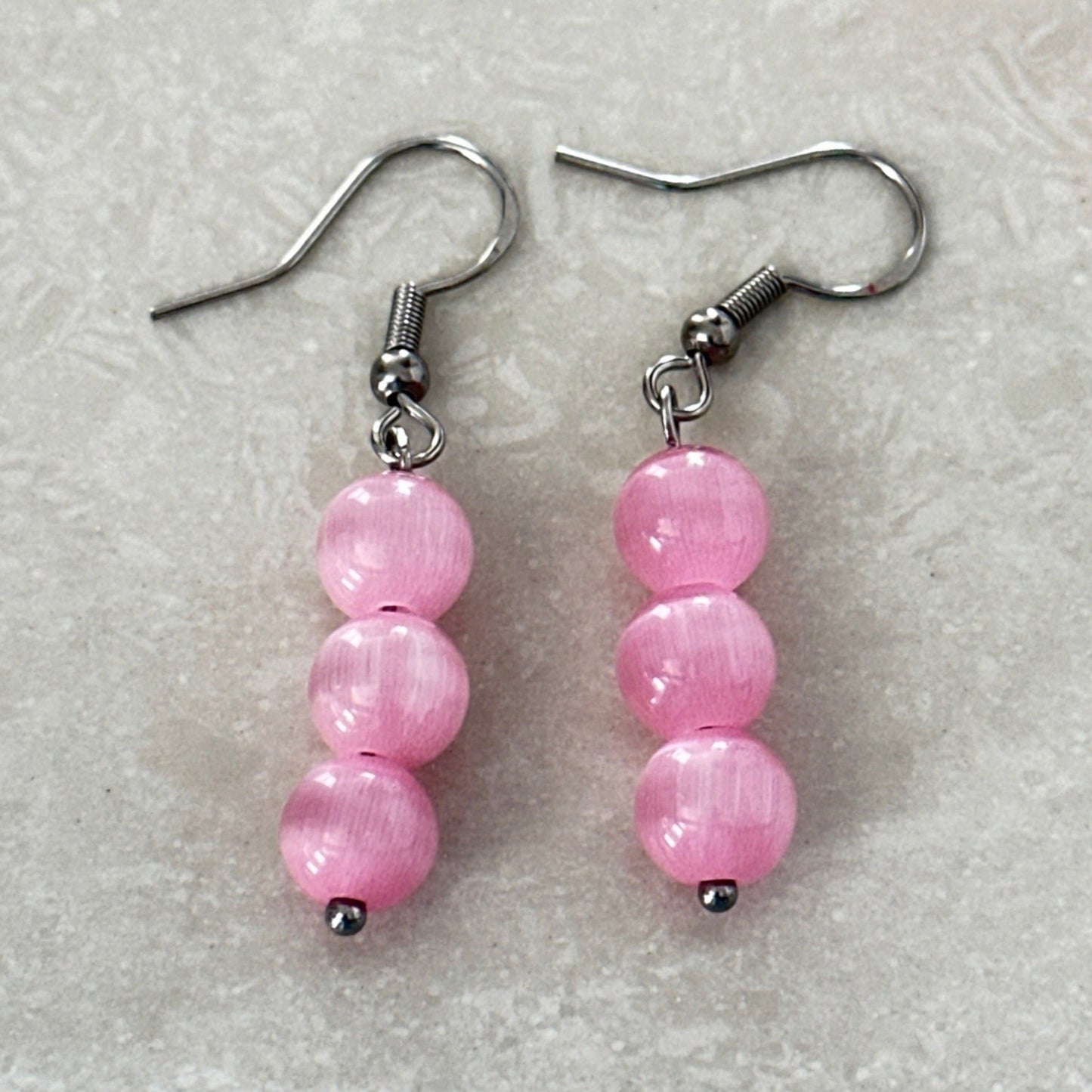 Elegant glass bead earrings showcasing Cat Eye shimmer - Uplift Beads