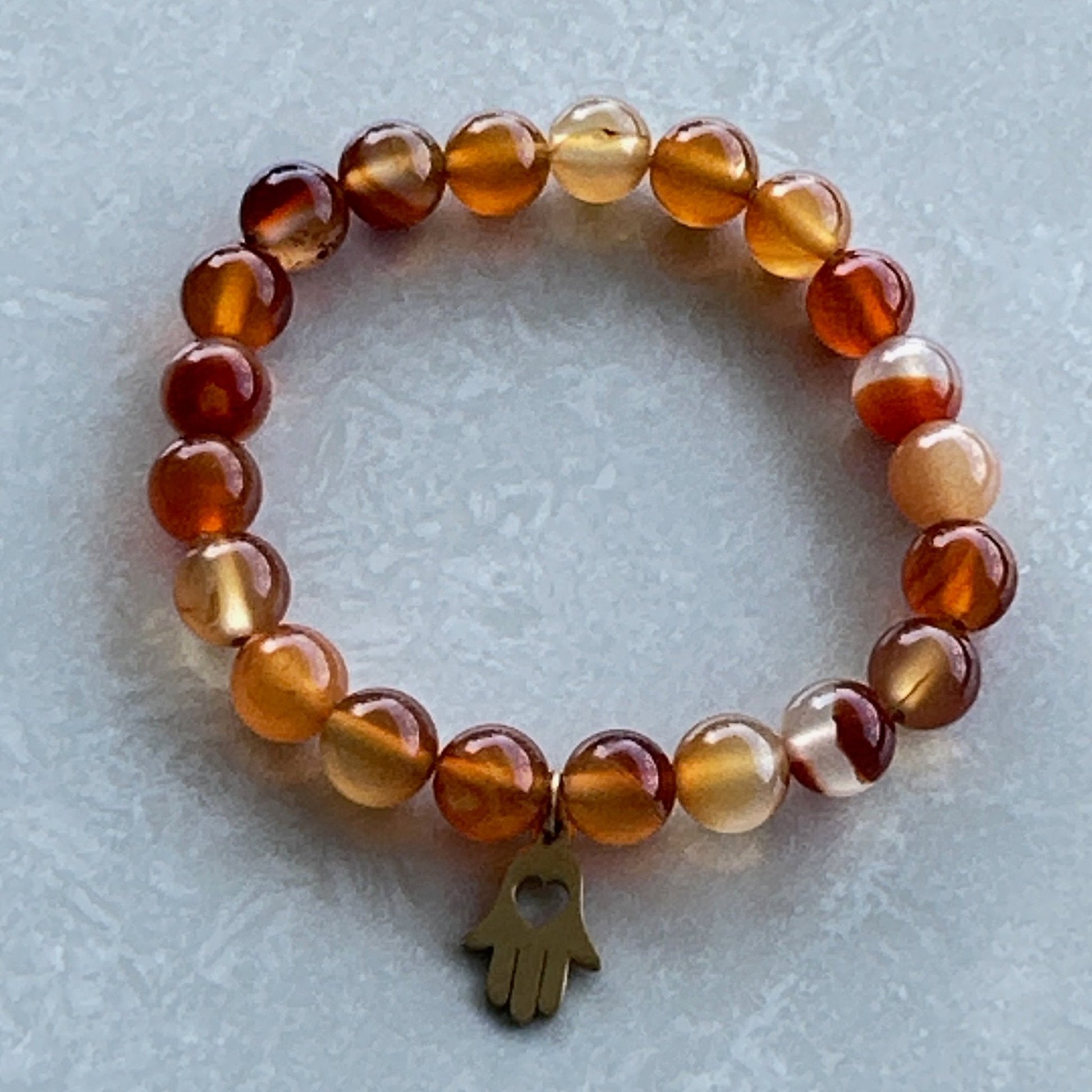 Handmade Carnelian bracelet with hamsa symbol - Uplift Beads
