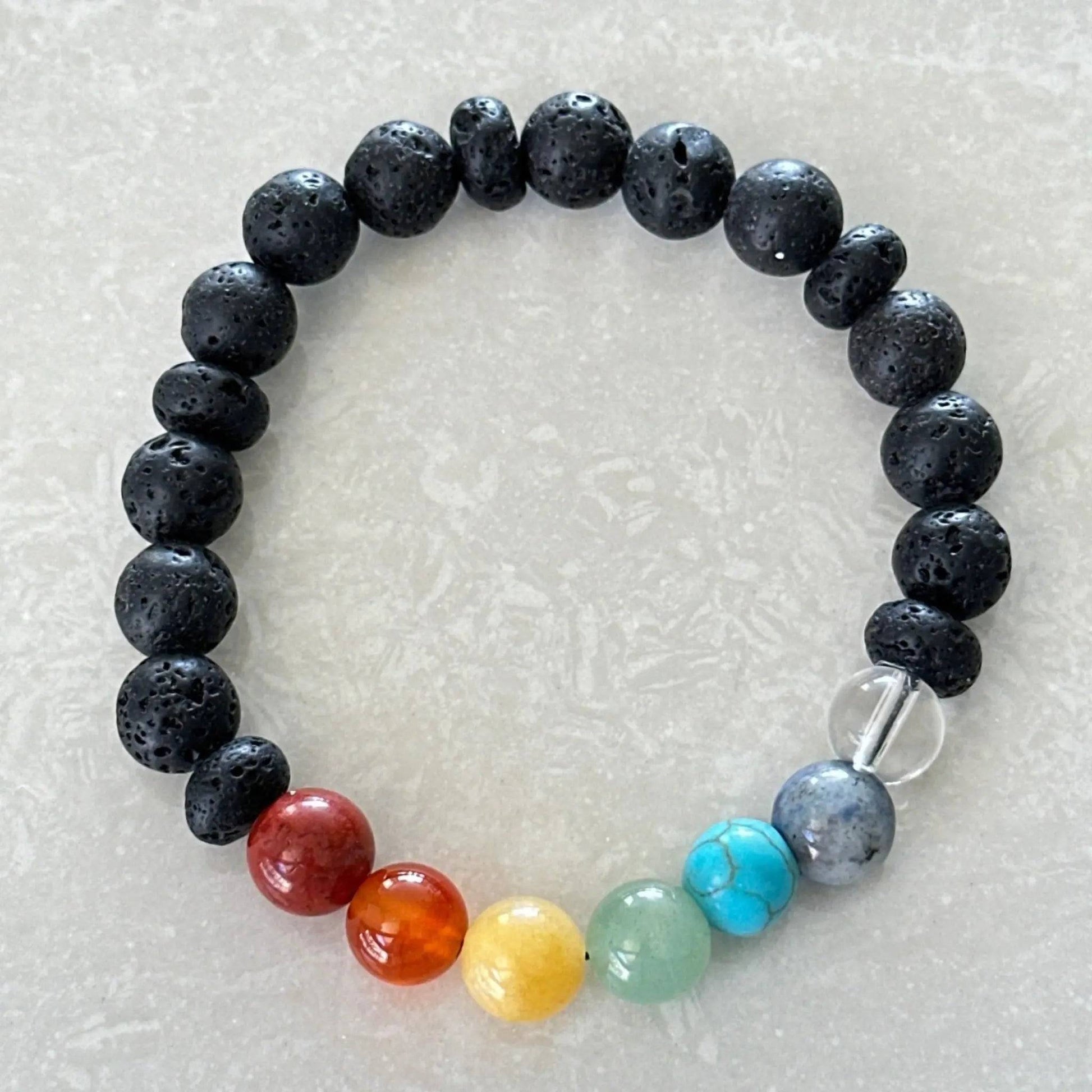 Chakra bracelet featuring colorful gemstones and aromatherapy lava beads - Uplift Beads