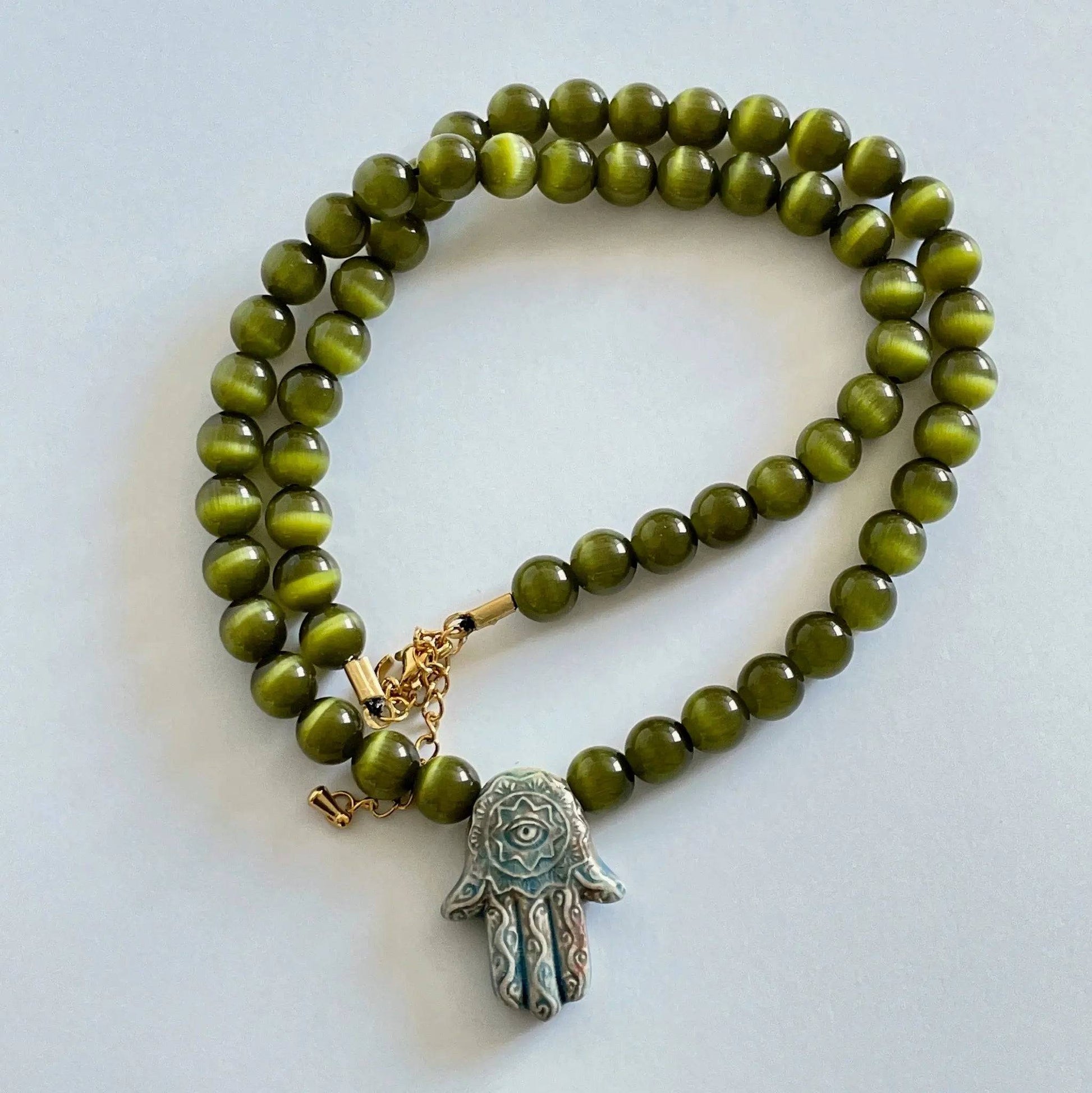 Hamsa Raku Necklace featuring luminous Cat Eye glass beads - Uplift Beads